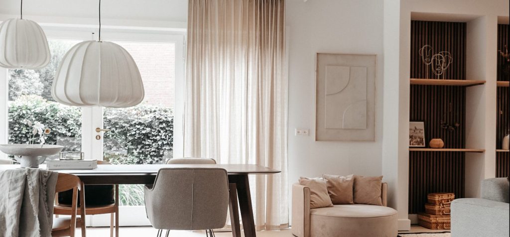 Walnut akupanel on the wall in a living room behind decorative shelf spaces